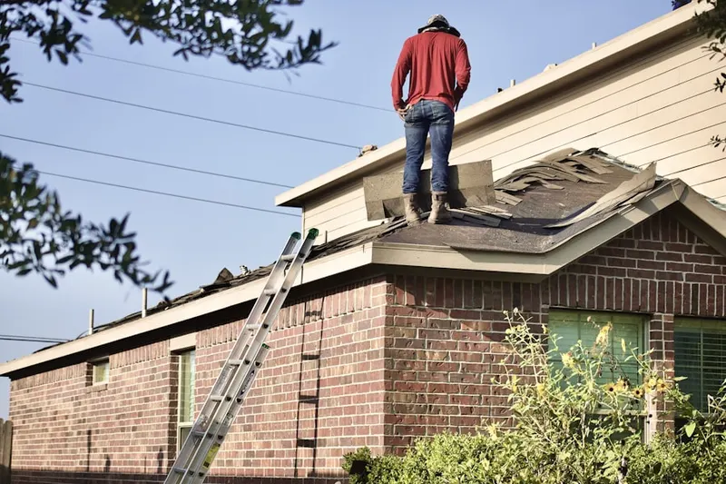 Professional roofer working on a residential roof in Oak Hill Court